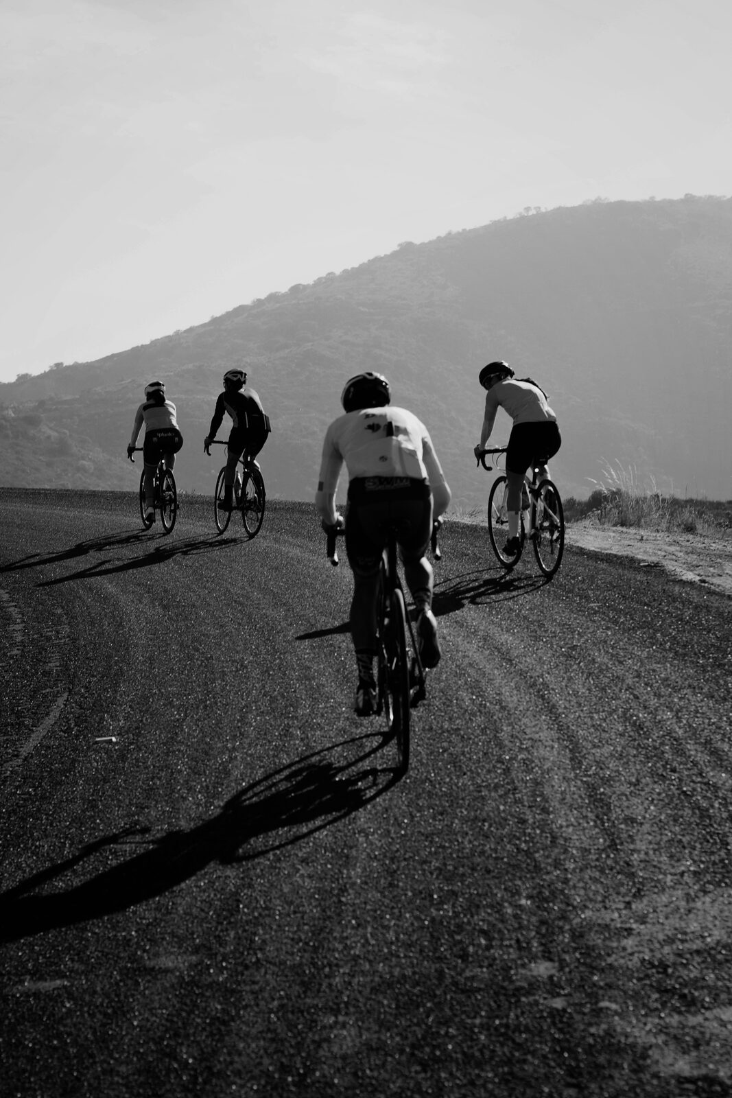Road cyclist on a mountain road at first light